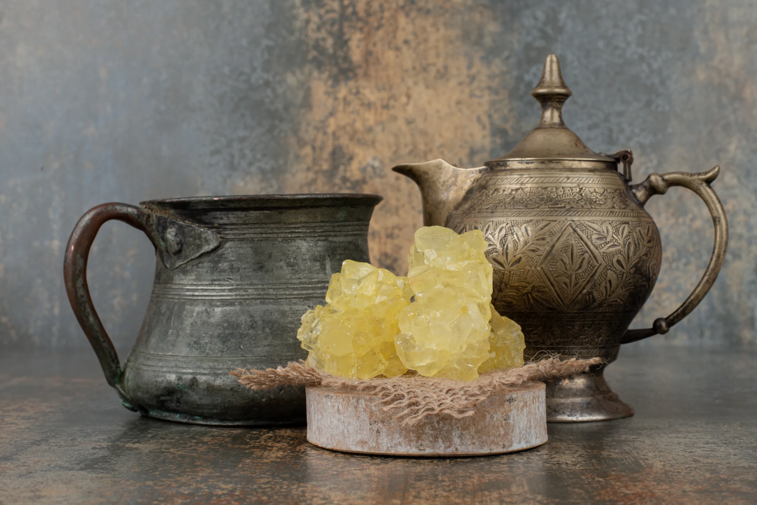 two ancient kettles with slices sweet sugar marble wall scaled